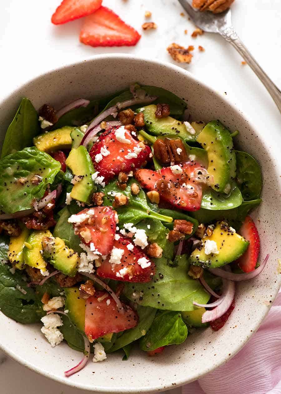 Overhead photo of Strawberry Salad with Avocado in a rustic bowl, ready to be eaten