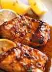 Close up of Marinated Grilled Salmon with lemon wedges