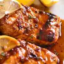 Close up of Marinated Grilled Salmon with lemon wedges