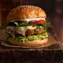 Close up of juicy, flavour loaded Avocado Chicken Burgers, ready to be eaten