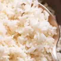Close up photo of perfect fluffy rice cooked on the stove
