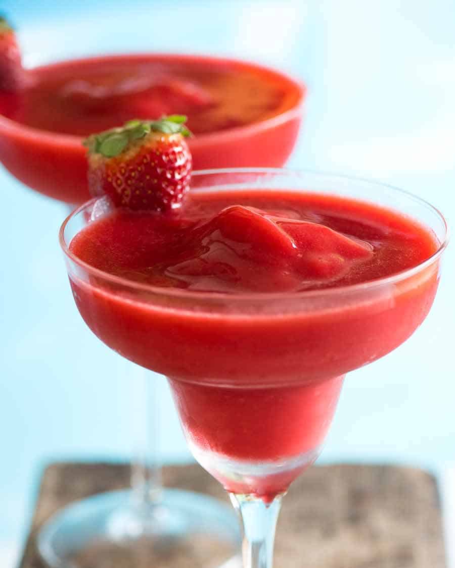 Close up of Frozen Strawberry Daiquiris by the pool - best summer cocktail!
