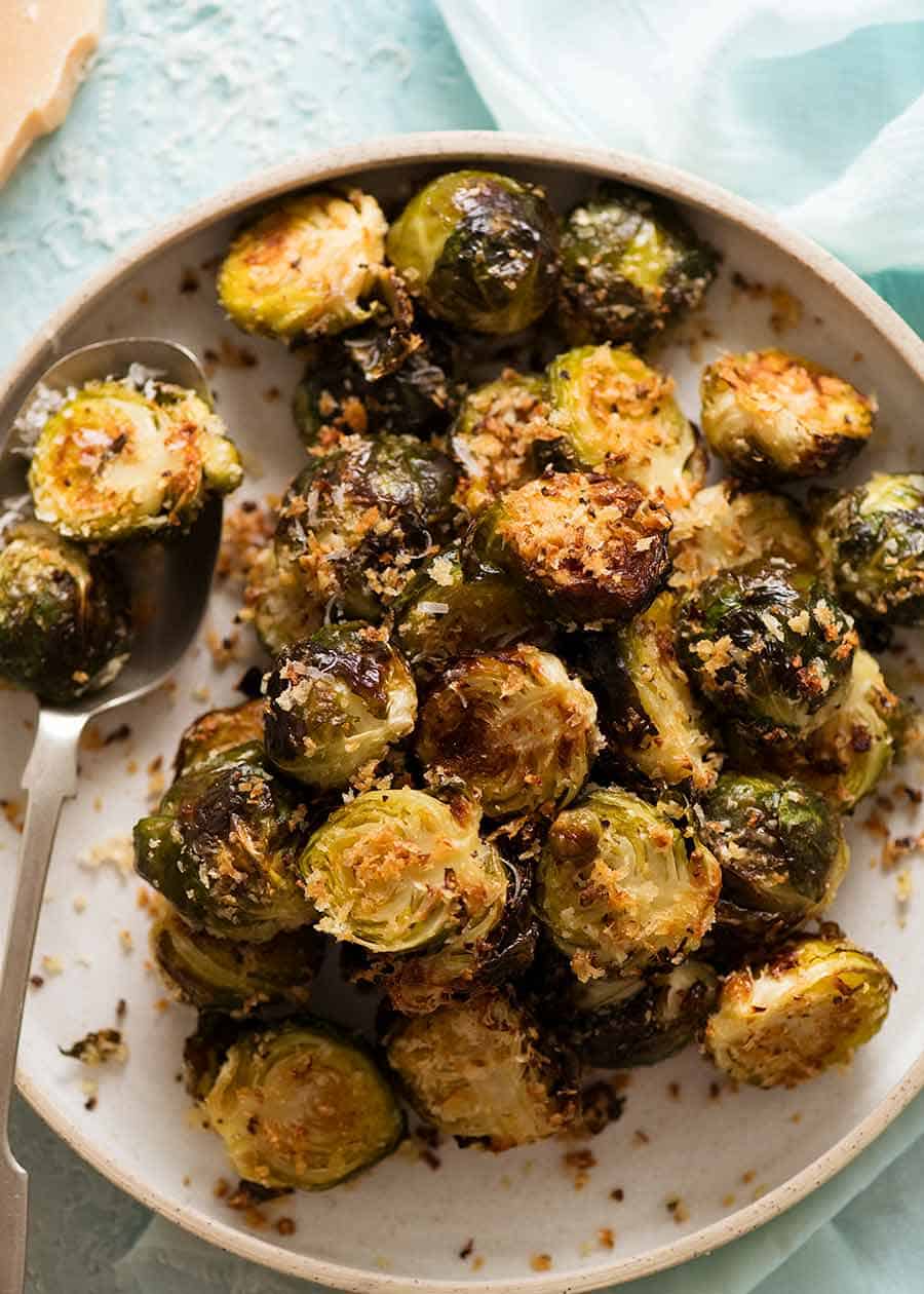 Plate piled high with CRISPY Parmesan Garlic Roasted Brussels sprouts