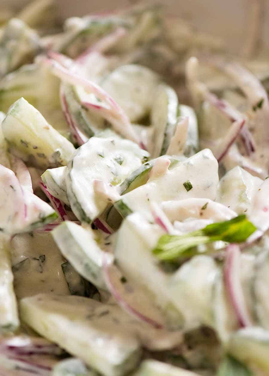 Close up of Cucumber Salad with Lemon Mint Yogurt Dressing in a white bowl