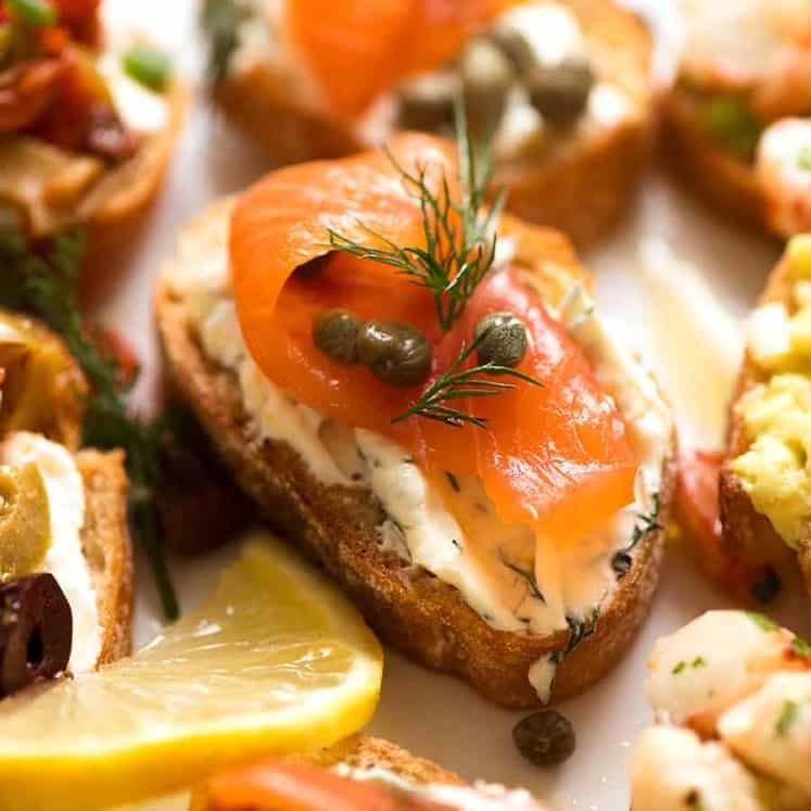 Close up of Smoked Salmon Crostini with cream cheese, dill, lemon and capers