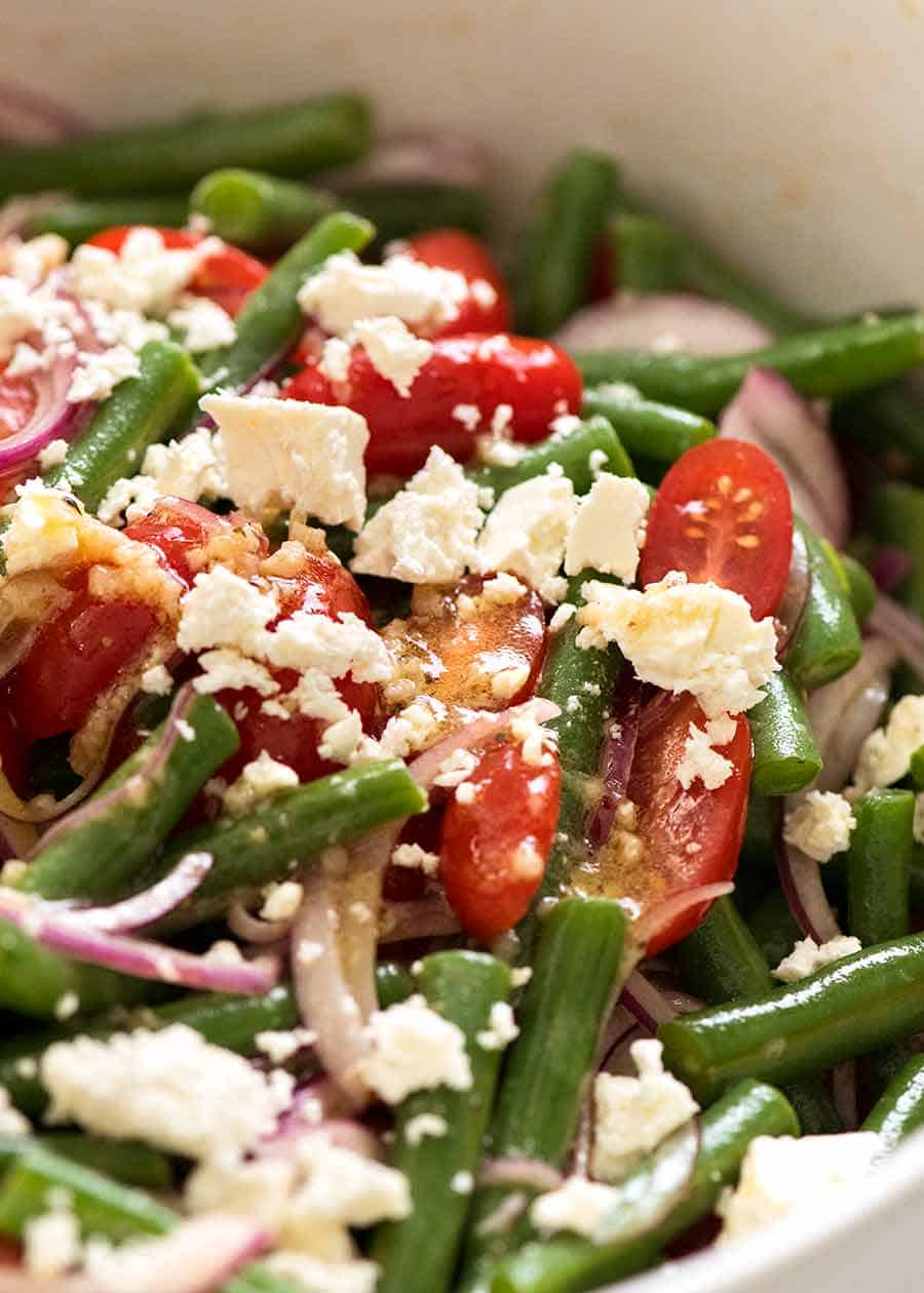 Close up of Green Bean Salad with Cherry Tomatoes and Feta in a white salad bowl, ready to be served
