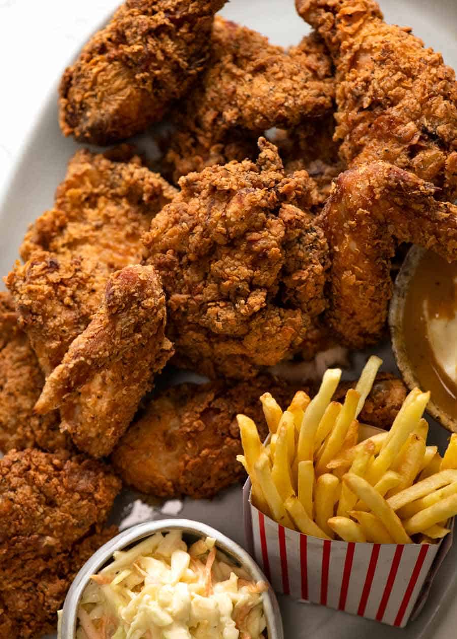 Pile of Fried Chicken with sides - Coleslaw, fries, potato and gravy