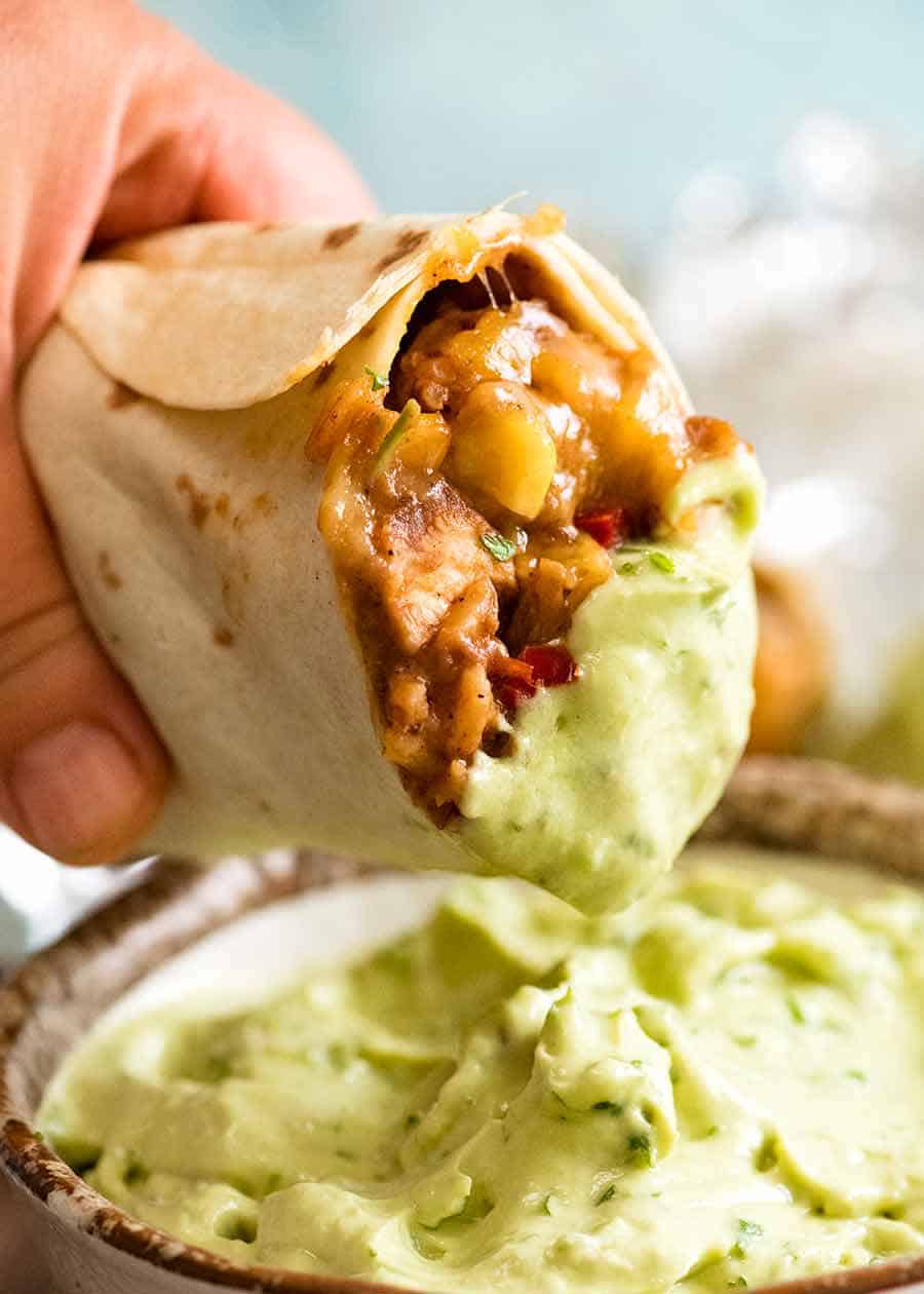 Dunking Chicken Burrito into Avocado Sauce