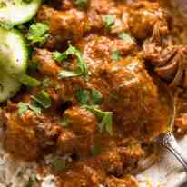 Close up of Rogan Josh in a rustic bowl, served over basmati rice