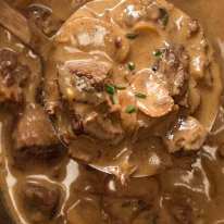 Close up of ladle scooping up Slow Cooker Beef Stroganoff