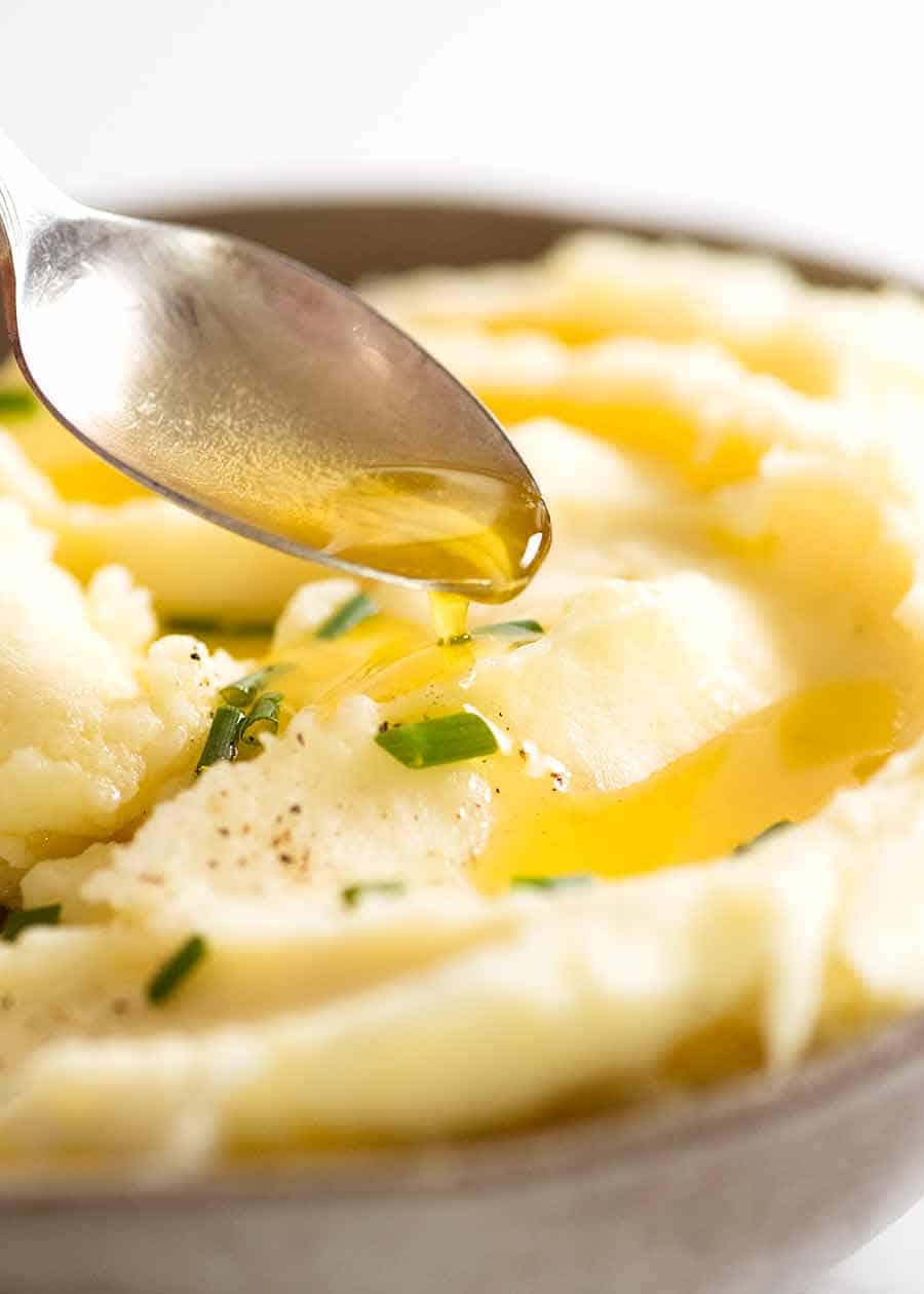 Drizzling butter over creamy mashed potato