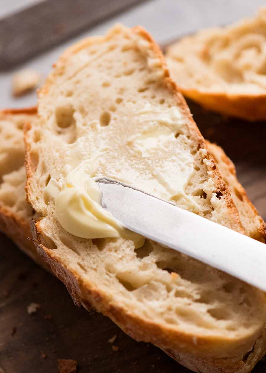 Spreading butter on homemade bread