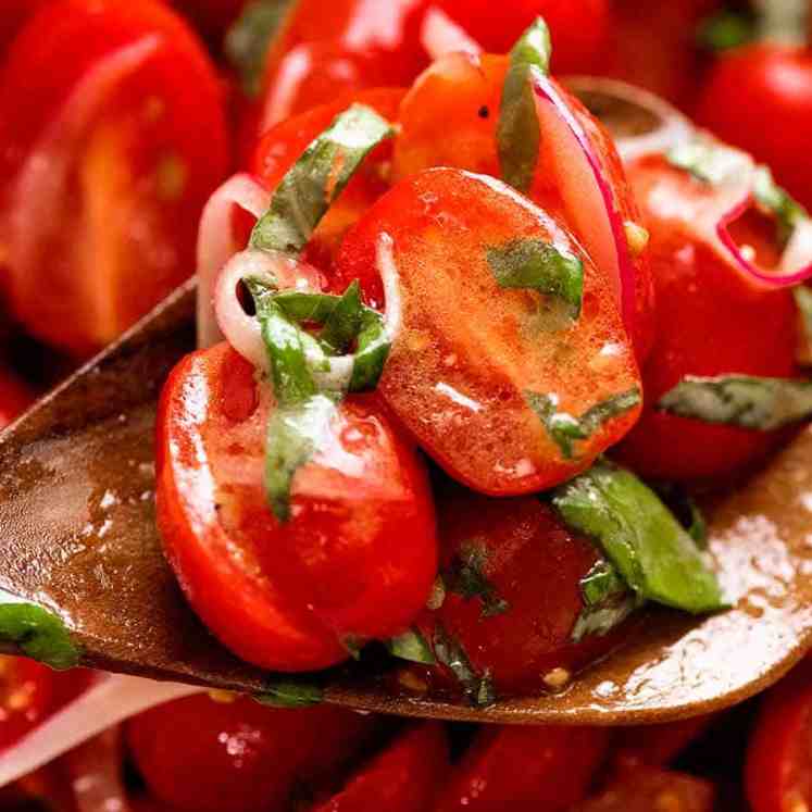 Close up of spoon scooping up Tomato Salad