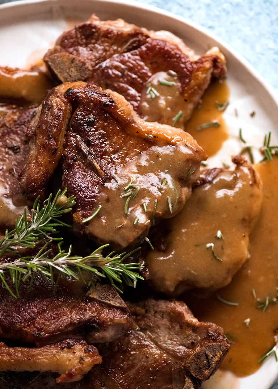 Plate of Lamb Chops with Rosemary Gravy garnished with rosemary
