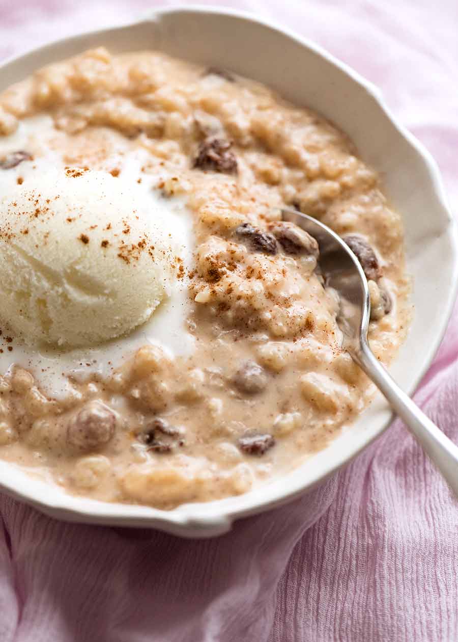 Creamy rice pudding in a bowl with ice cream, ready to be eaten