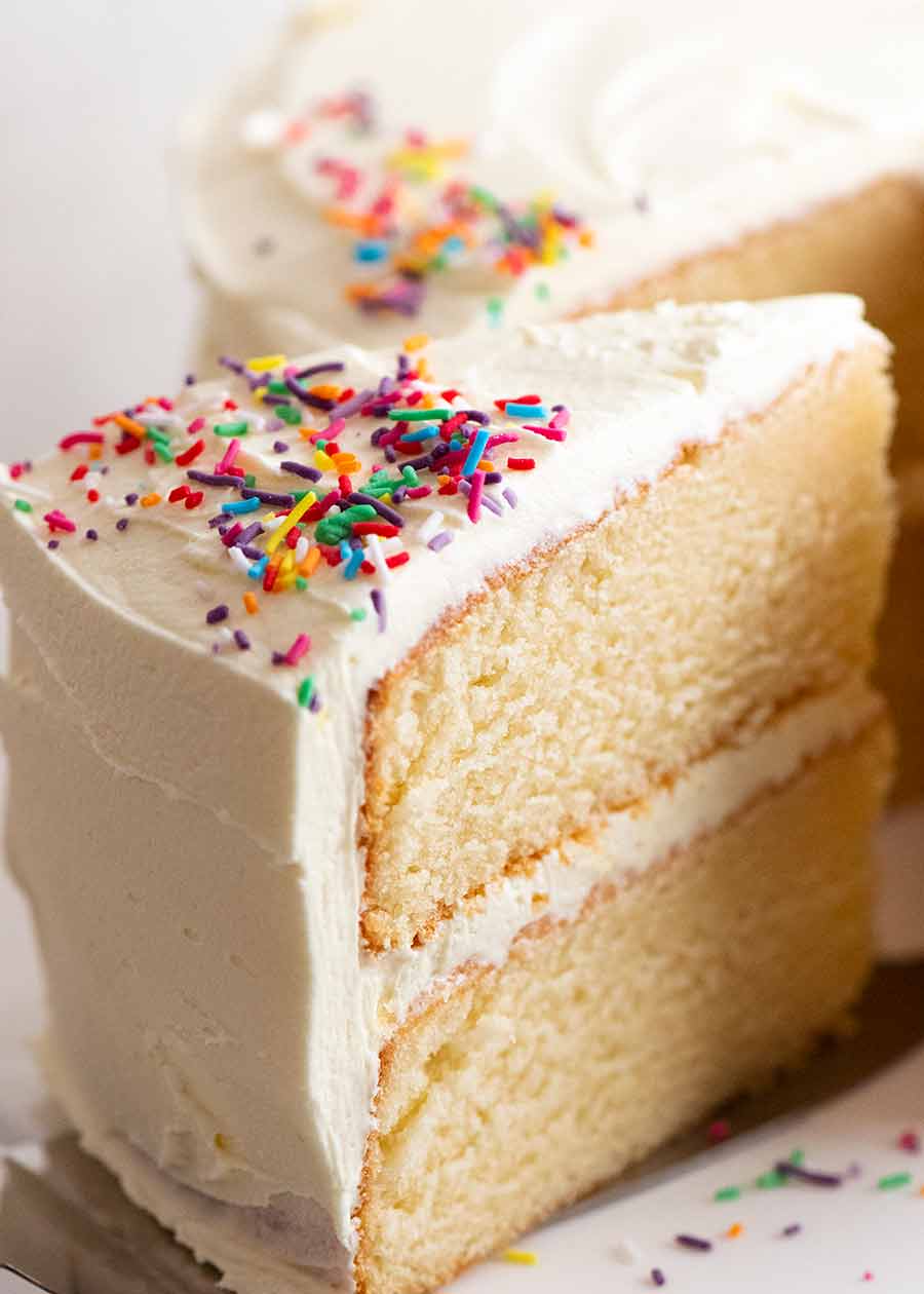 Close up of a slice of an incredible Vanilla Cake with fluffy buttercream frosting
