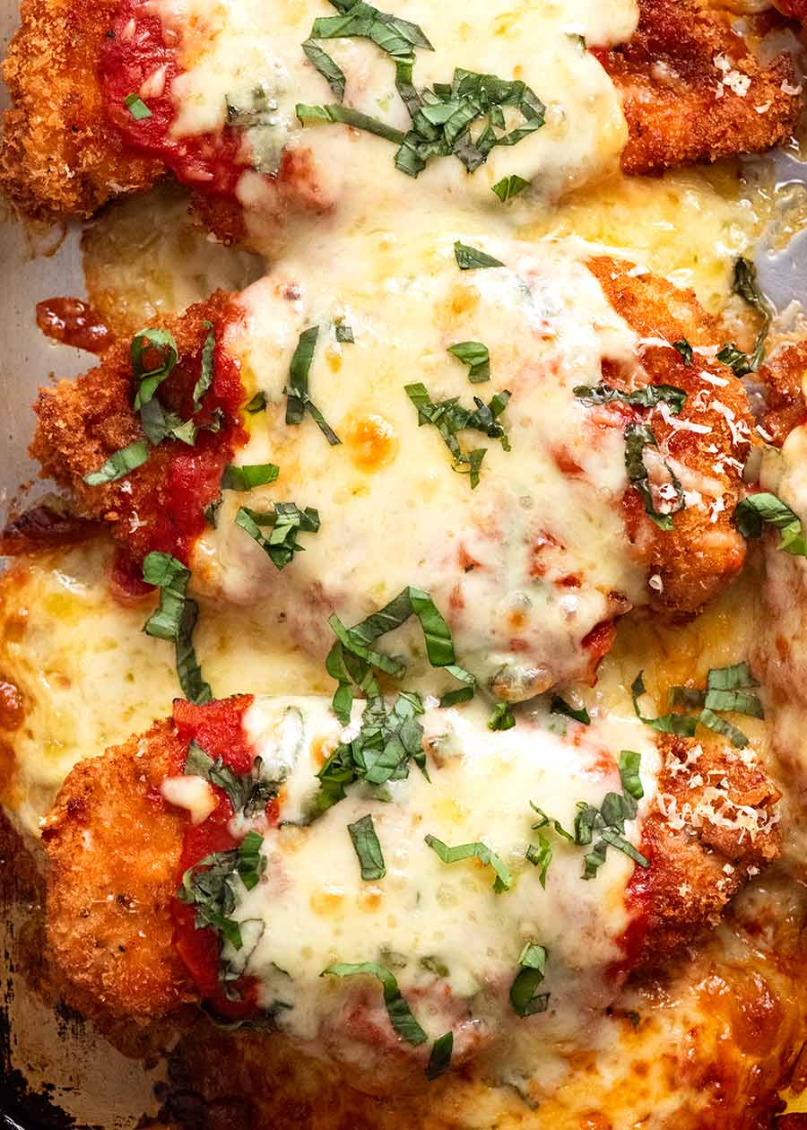 Overhead photo of Chicken Parmigiana (Chicken Parmesan) on a tray, fresh out of the oven