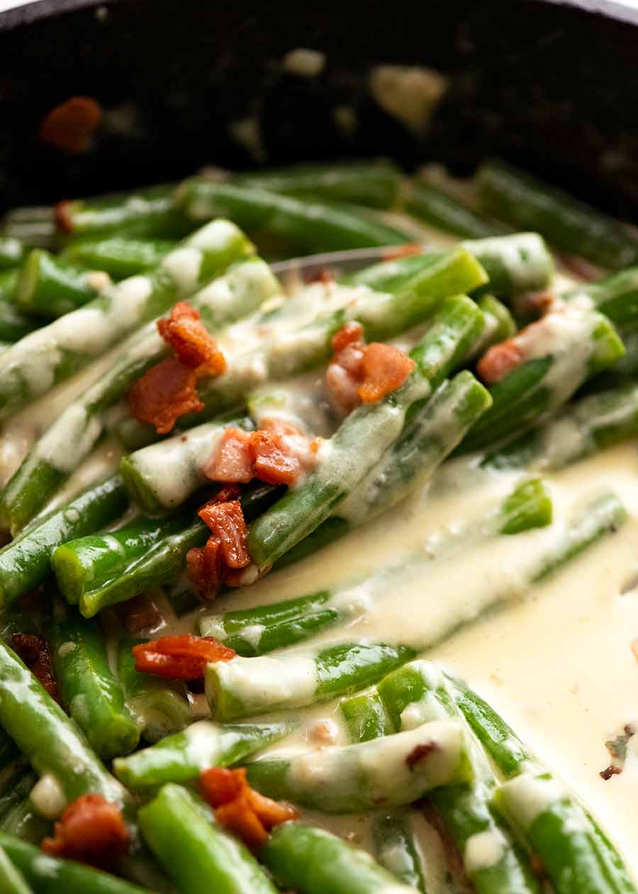 Close up of Green beans in creamy parmesan sauce in a skillet, fresh off the stove