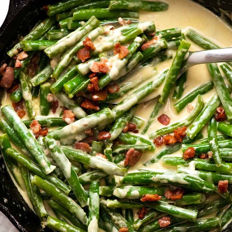 Overhead photo of Green beans in creamy parmesan sauce with bacon