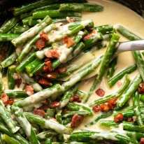 Close up photo of Green beans in creamy parmesan sauce with bacon