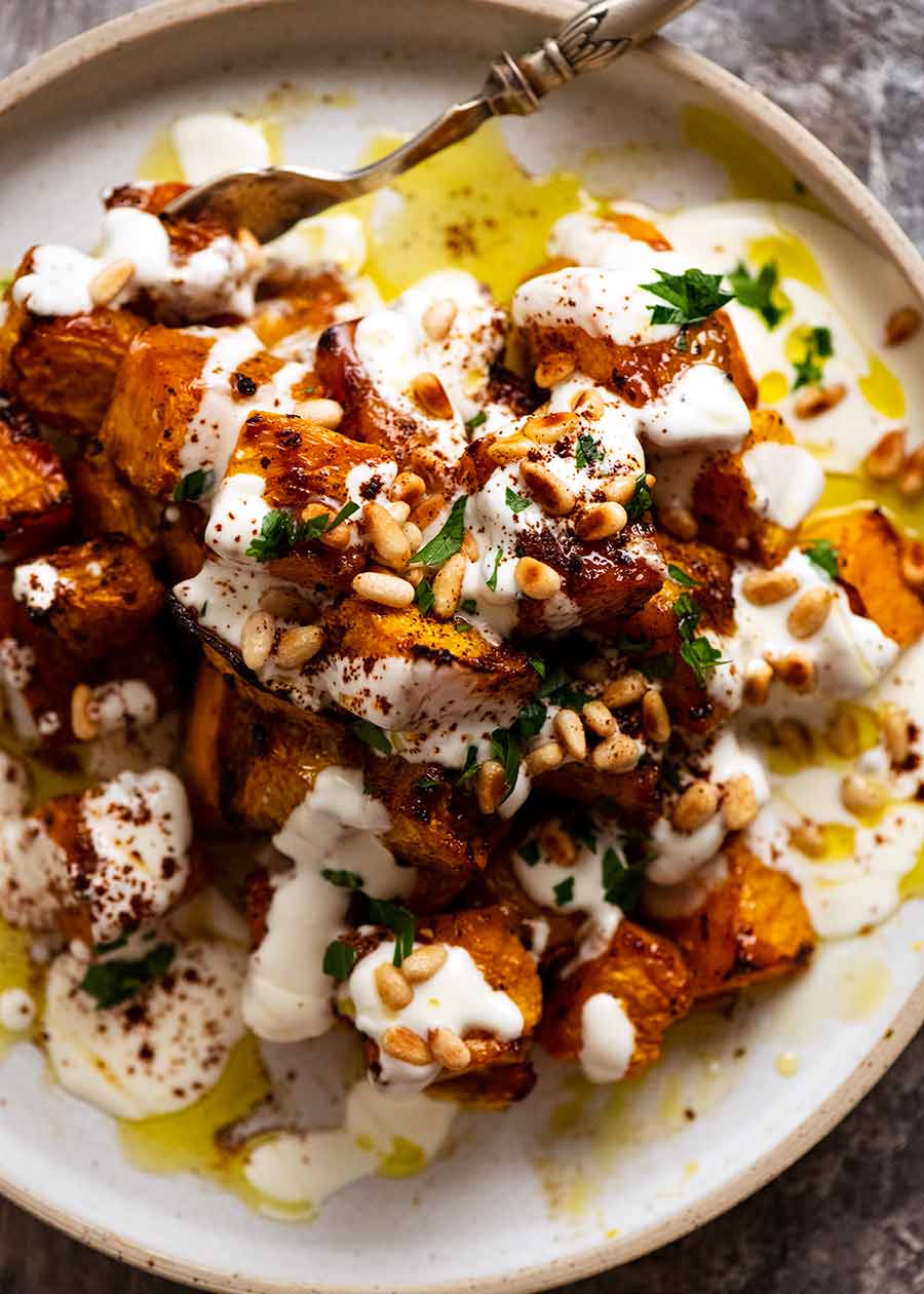Roast Pumpkin with Yogurt Sauce and Pine Nuts on a plate, ready to be served