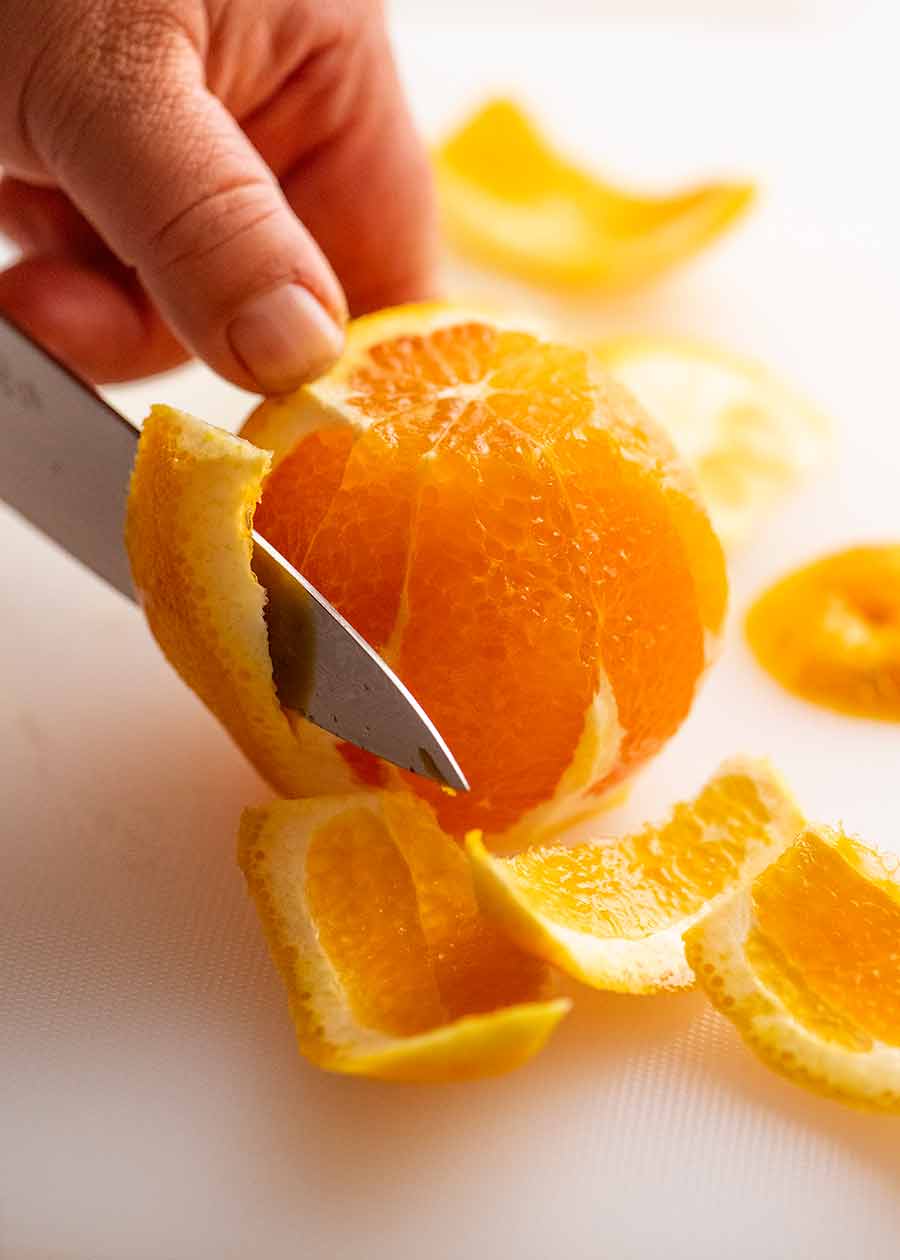 Cutting skin off oranges