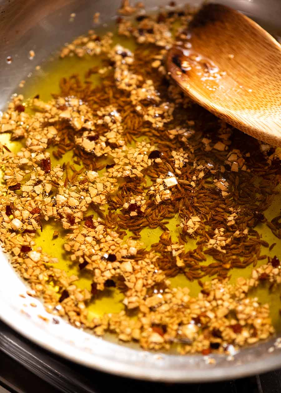 Golden garlic and cumin in olive oil for New York Times Broccoli Salad