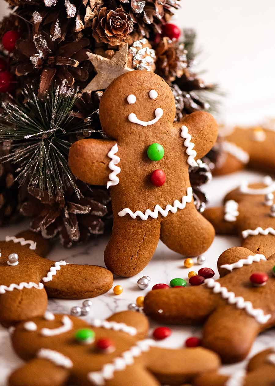 Gingerbread Men propped up on a mini Christmas tree