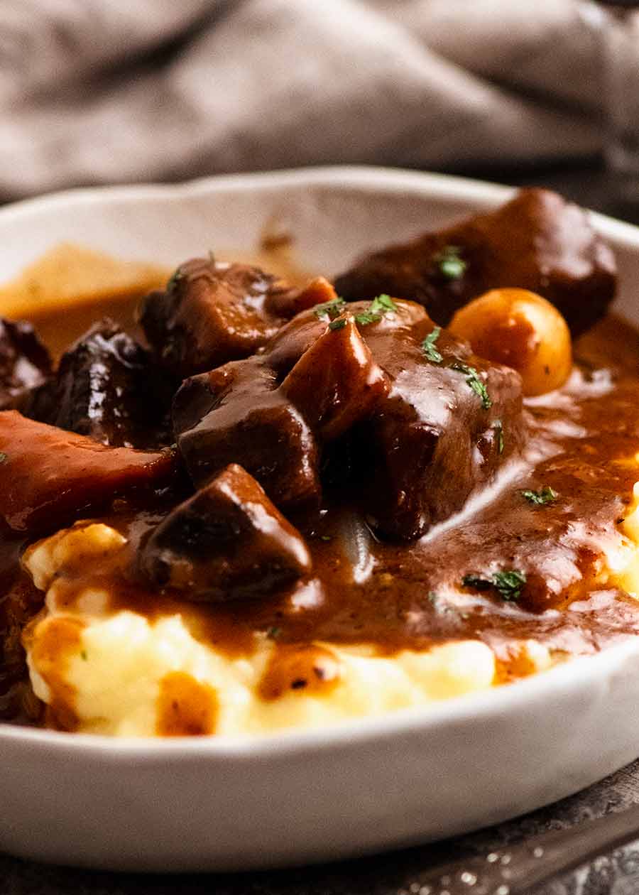 Beef Bourguignon in a bowl served over creamy mashed potato