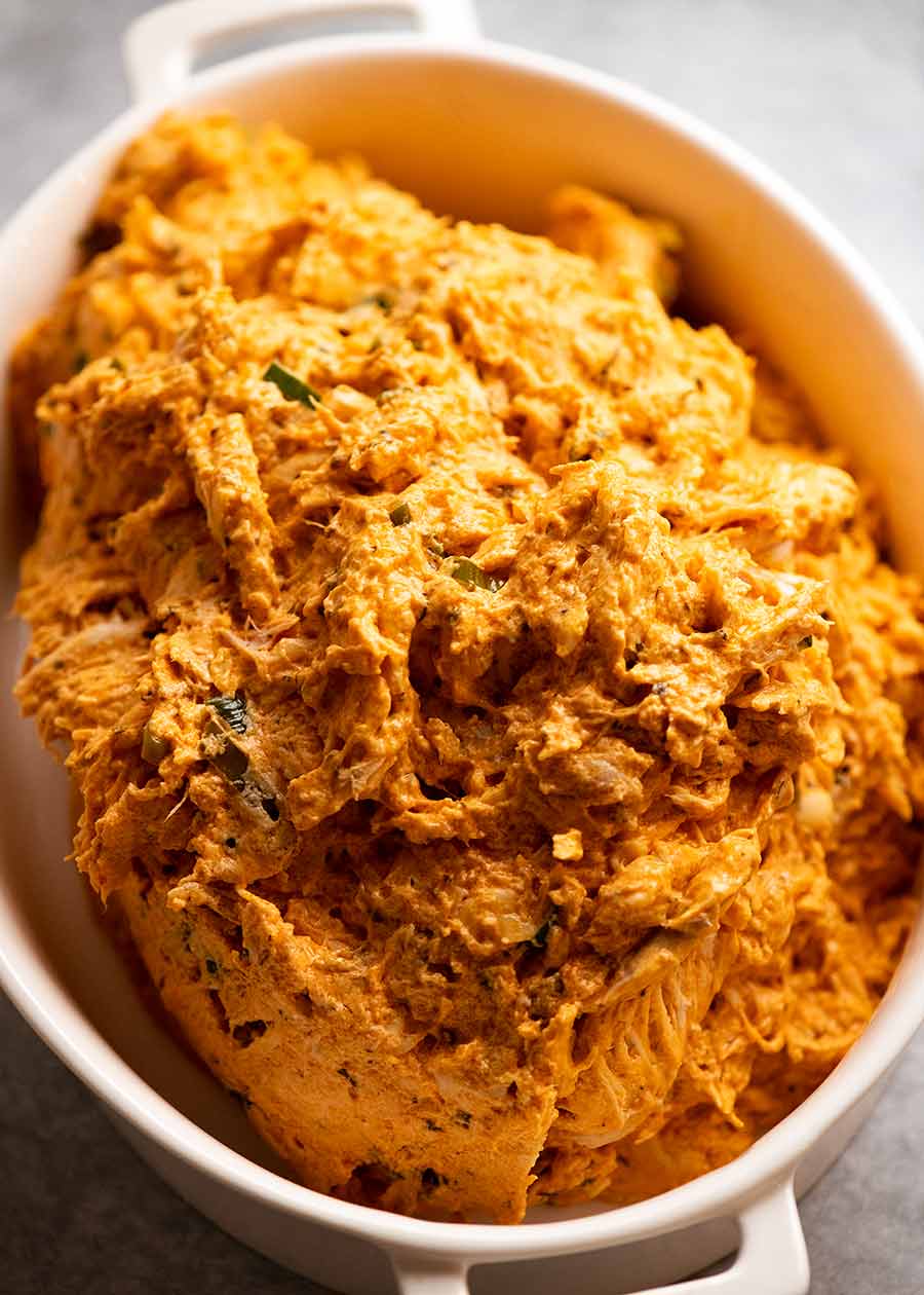 Hot Buffalo Chicken Dip filling in a casserole dish, ready to be baked