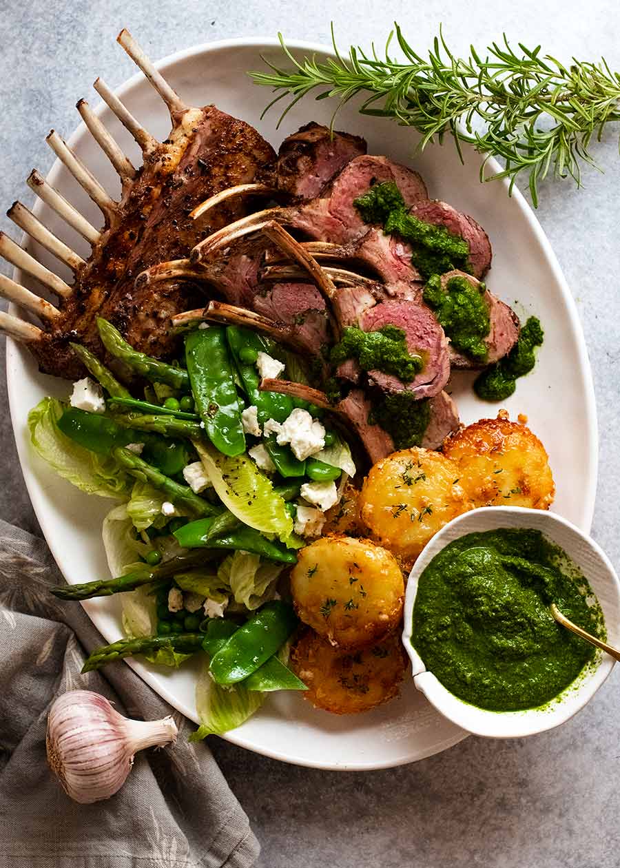Overhead plating styling of Rack of Lamb on a platter with side salad and mini Potato Gratin