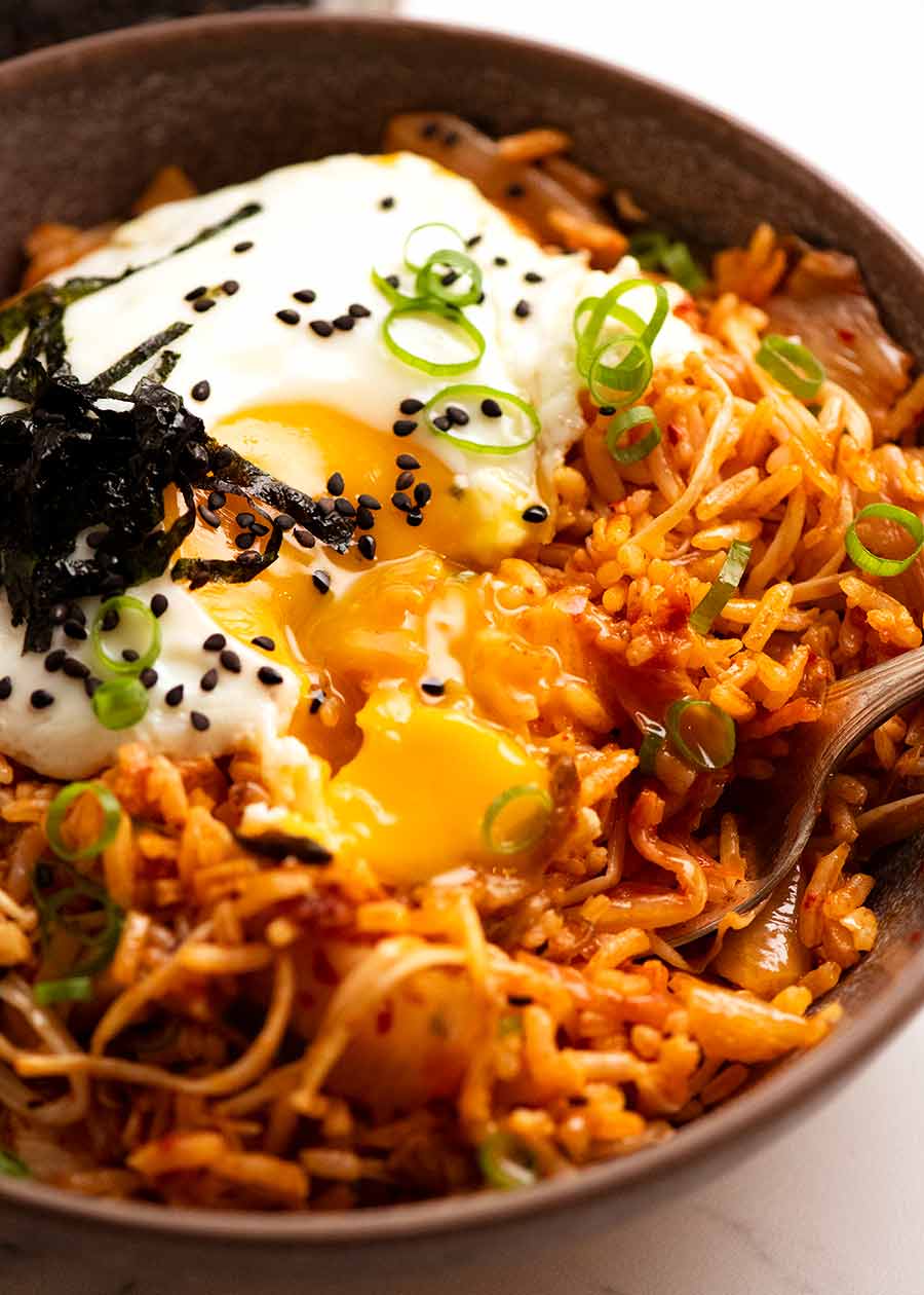 Close up of bowl of Kimchi Fried Rice with runny yolk