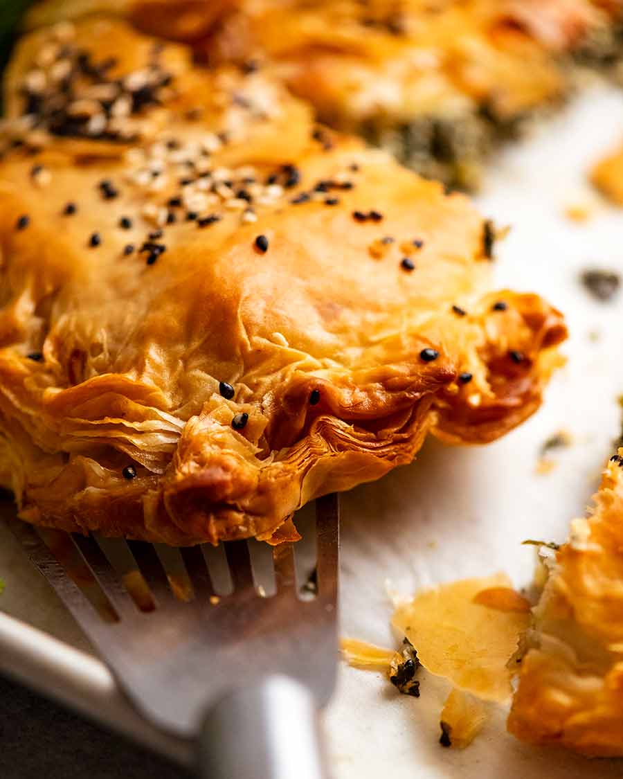 Close up showing crimped edge of flaky phyllo pastry edge of Spanakopita