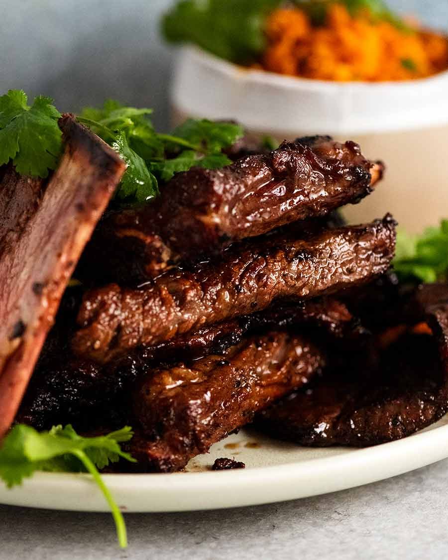 Stack of Korean BBQ Marinated Beef Short ribs (Galbi) on a plate, ready to be eaten
