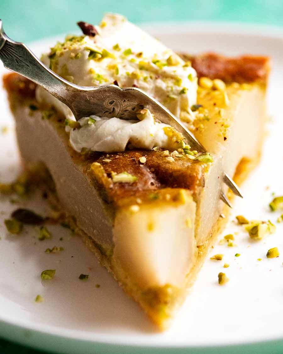 Fork cutting into a slice of Pistachio Pear Tart
