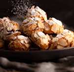 Dusting icing sugar over Italian Almond Cookies