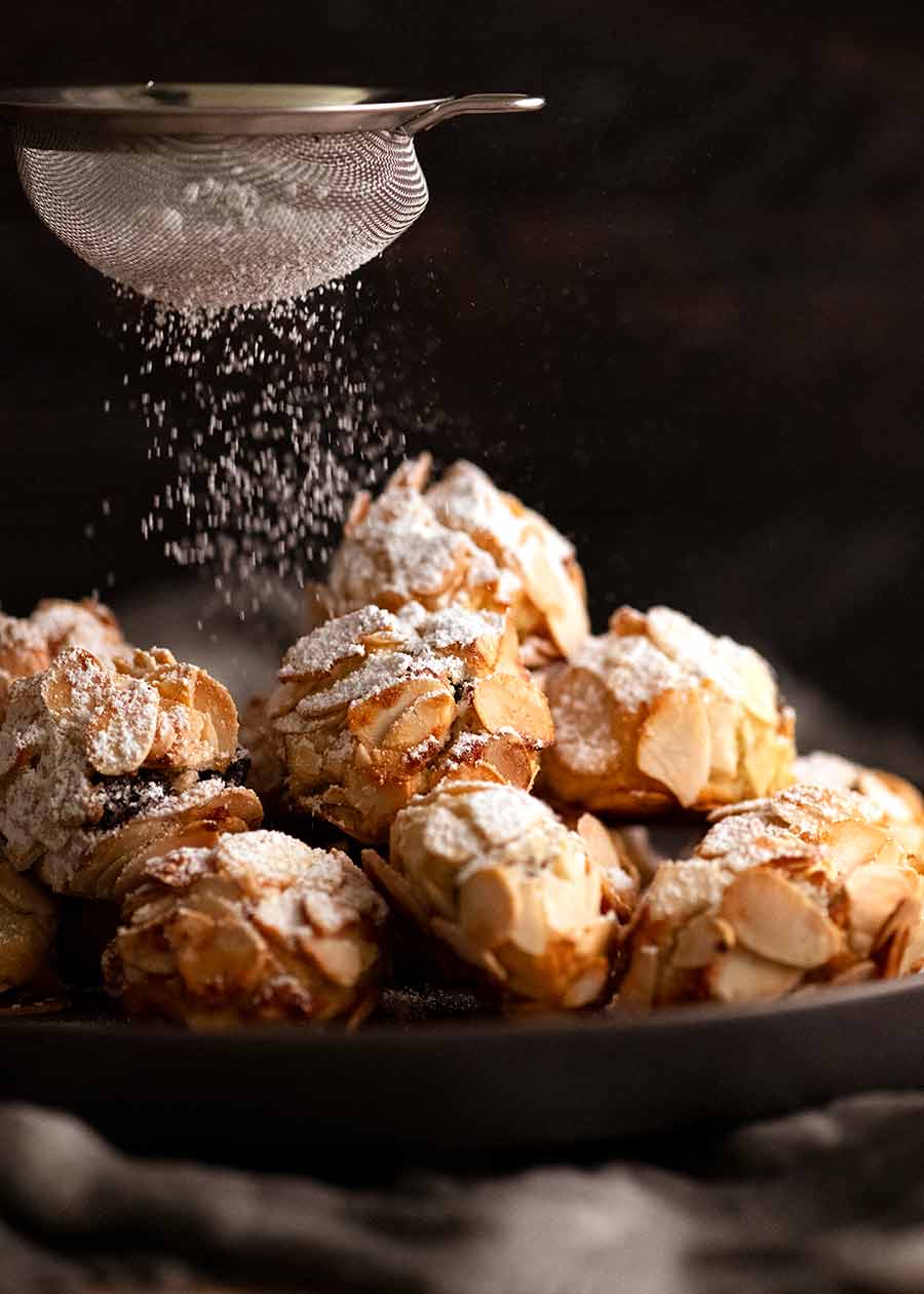 Dusting icing sugar over Italian Almond Cookies