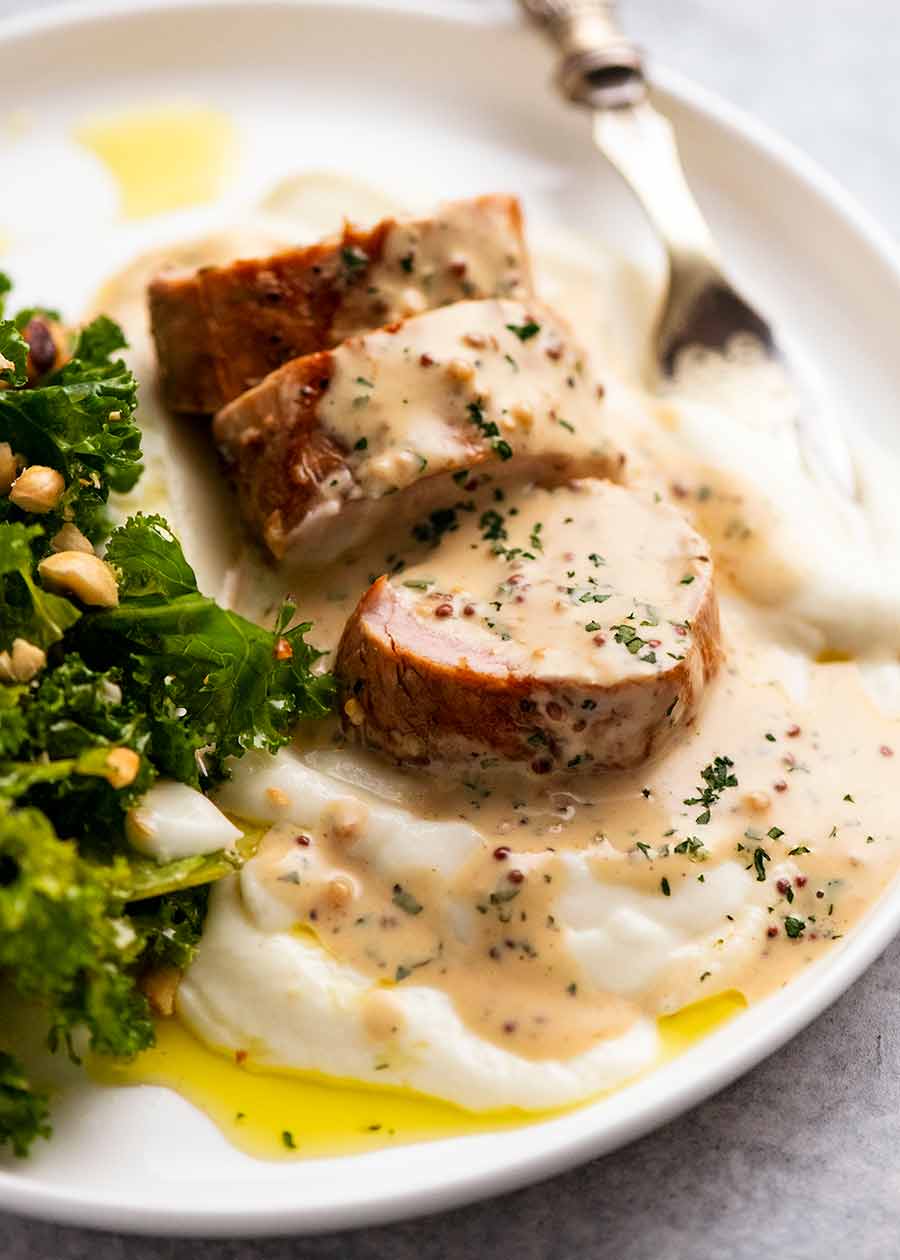 Pork Tenderloin with Creamy Mustard Sauce on a plate with a side of creamy mashed potato