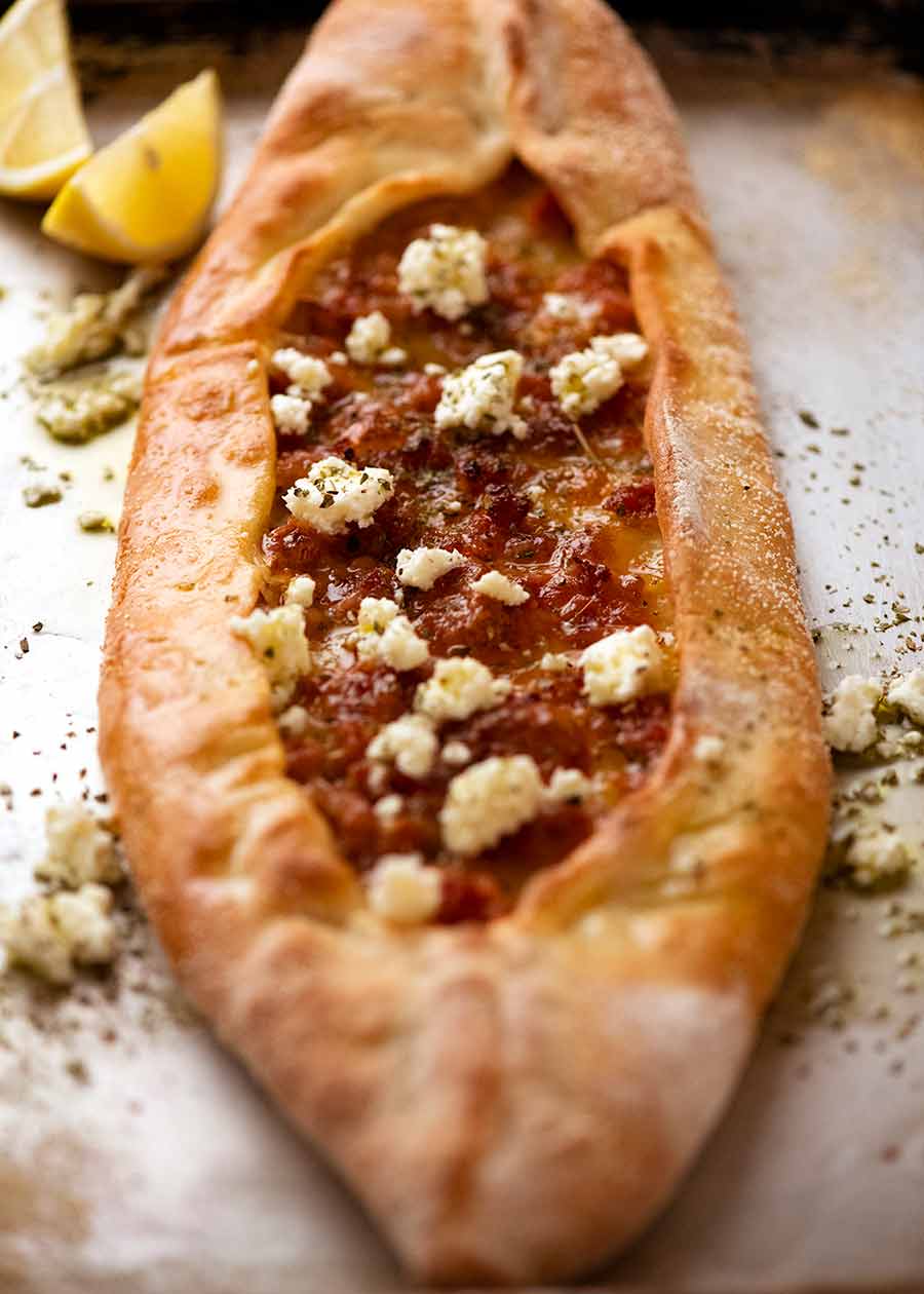 Turkish Sausage Pide on a tray, fresh out of the oven
