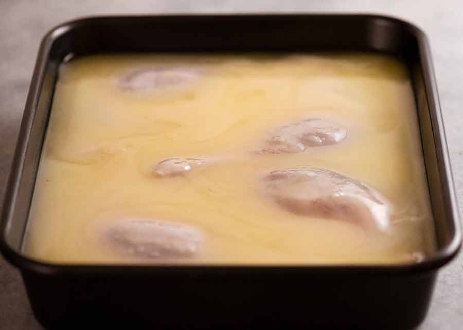 Duck Confit submerged in duck fat ready to be slow roasted