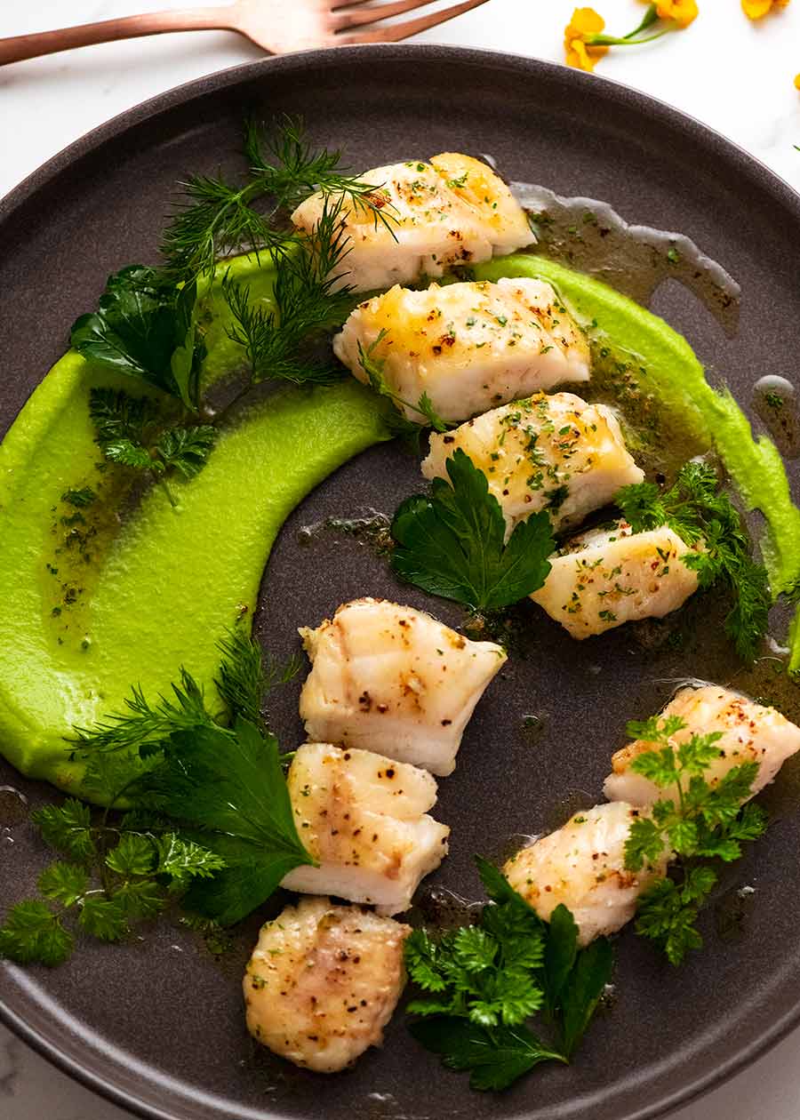 Monkfish on a plate with pea puree and Brown Butter Herb Sauce
