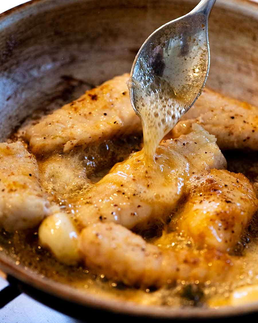 Spoon garlic butter over Monkfish