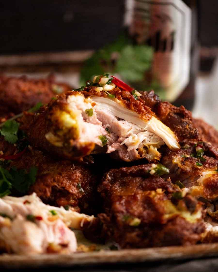 Showing the juicy inside of Ayam Goreng (Malaysian Fried Chicken)