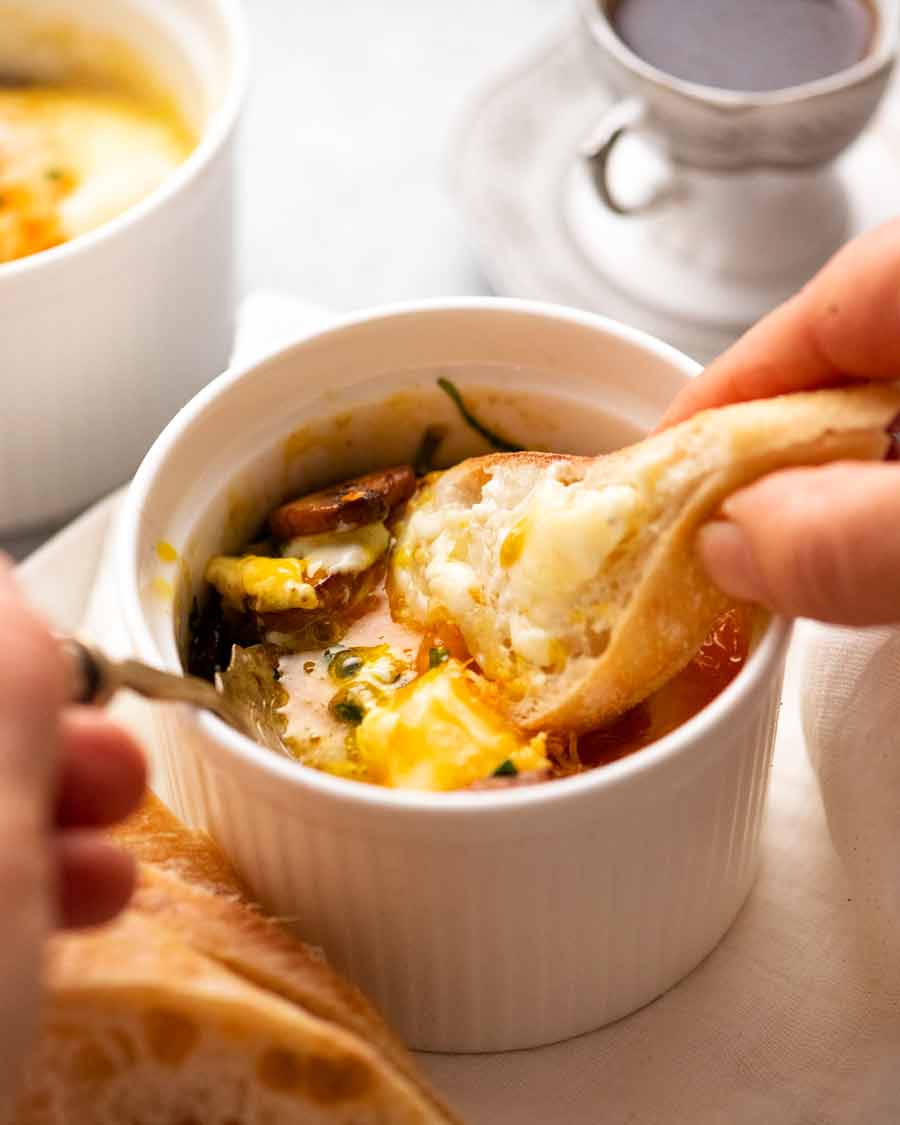 Dunking bread into Baked Eggs - Shirred Eggs