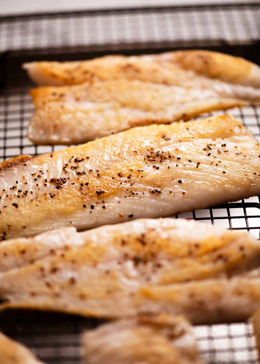 Cooked snapper fillets ready to be served with white wine sauce