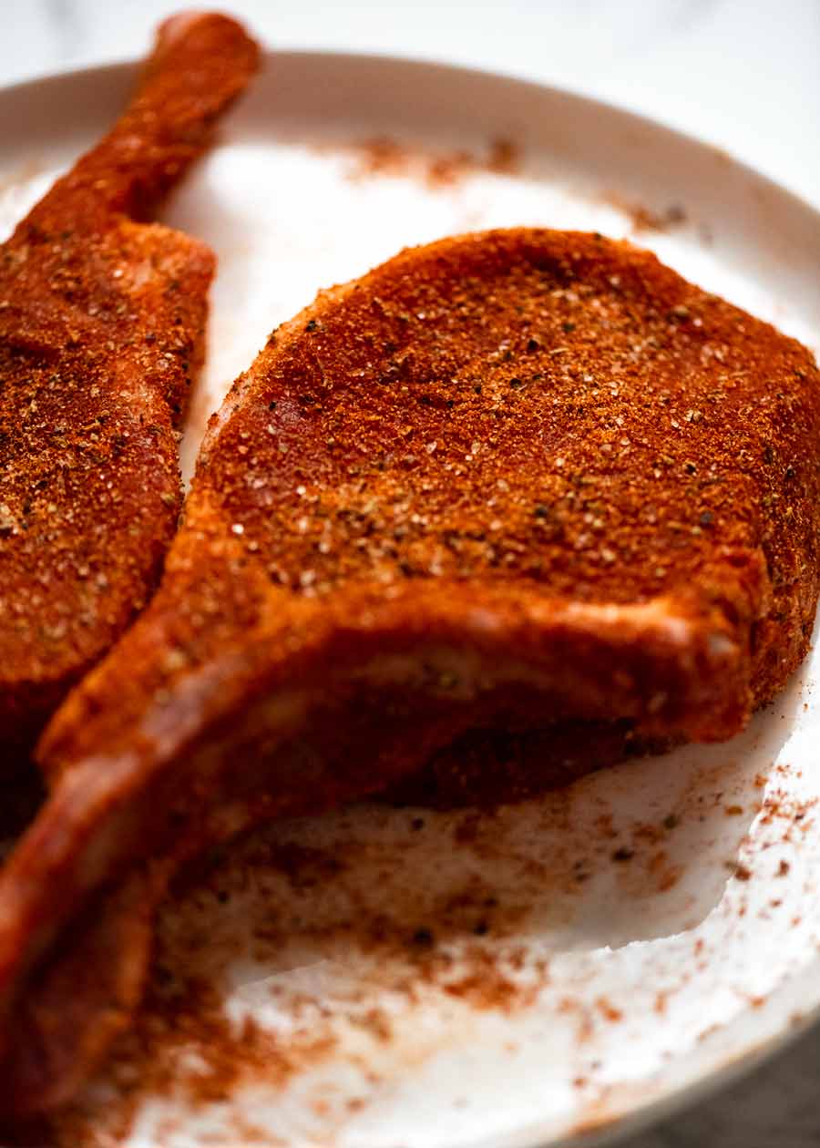 Raw pork chop seasoned with rub
