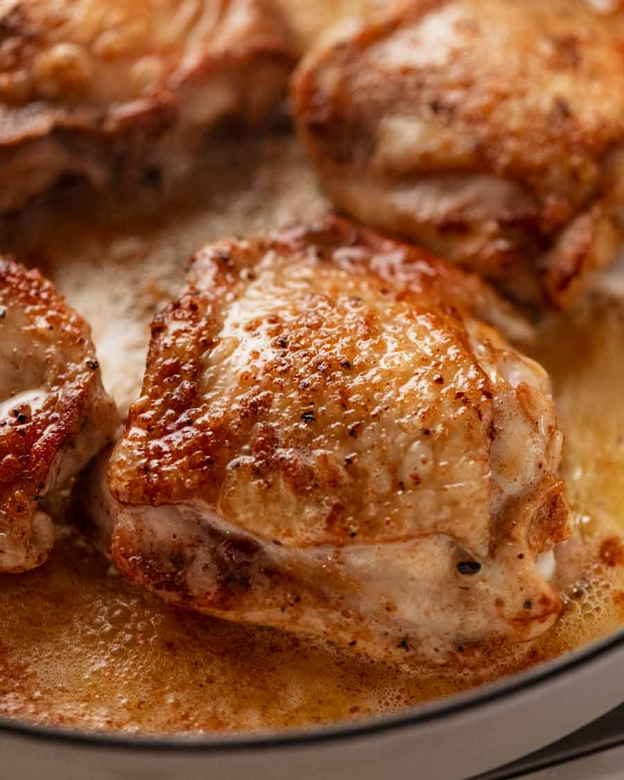Close up of golden brown seared chicken thigh cutlets