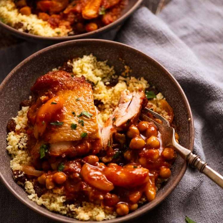 Moroccan Chicken Tagine served in a bowl on a bed of couscous