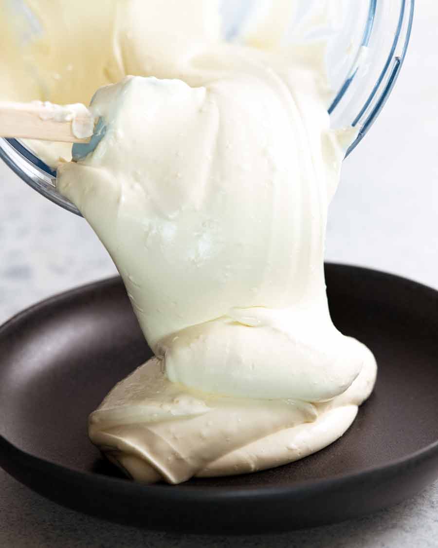 Pouring Creamy Feta Dip on a plate