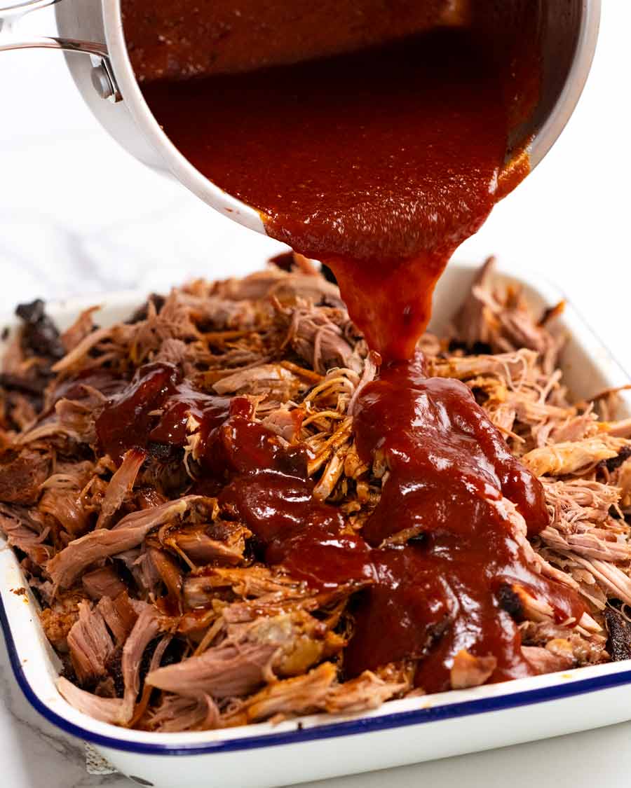 Pouring BBQ sauce over My best pulled pork